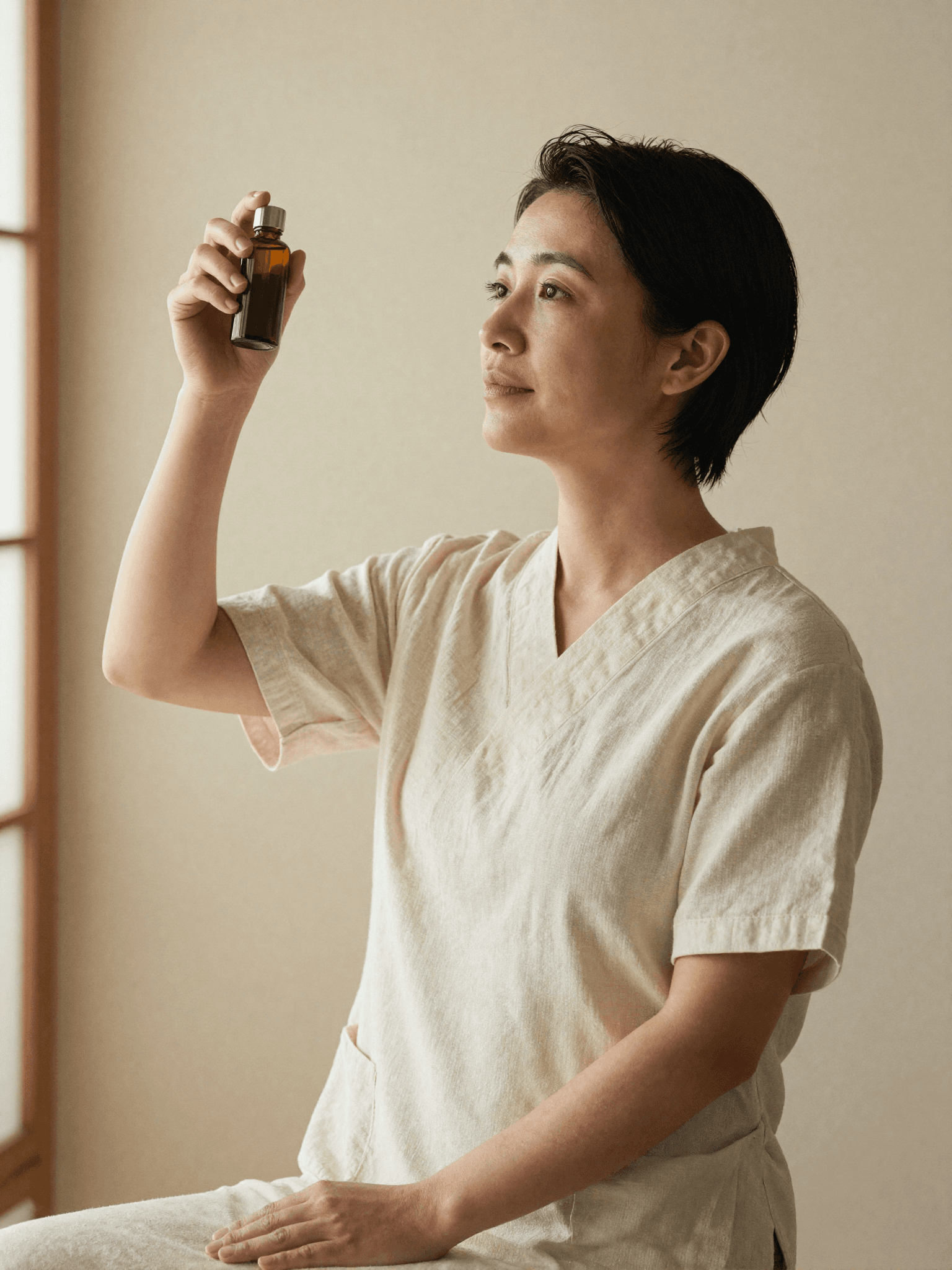 A hair wellness specialist at Yume Spa Milano preparing botanical products with care
