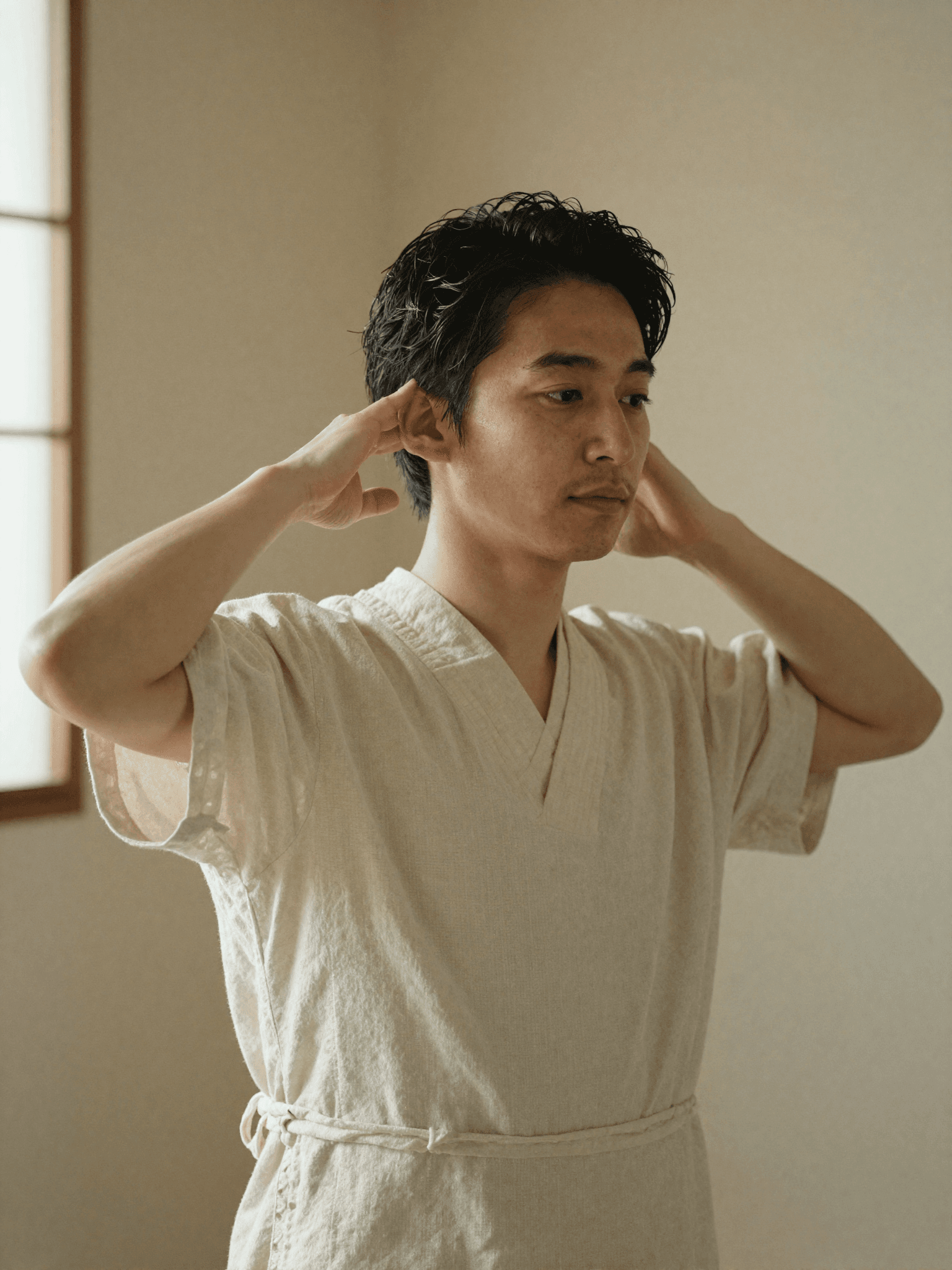 A Japanese Head Spa practitioner at Yume Spa Milano, mid-ritual, focused and composed